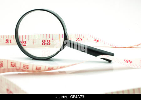 Magnifier and meter tape Stock Photo