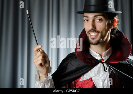 Magician doing tricks on white Stock Photo