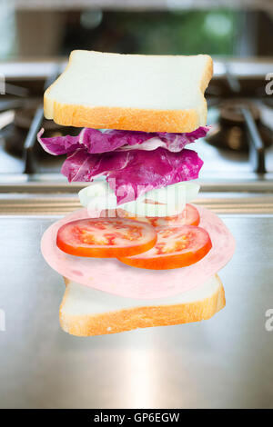Ham sandwich with ingredients floating Stock Photo