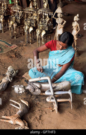 Woman crafting handicrafts out of wrought iron, bastar, chhattisgarh, india, asia Stock Photo