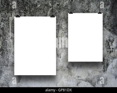 Close-up of two blank frames hanged by clips against gray old weathered concrete wall background Stock Photo
