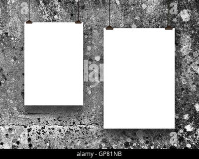 Close-up of two blank frames hanged by clips against gray concrete wall background Stock Photo