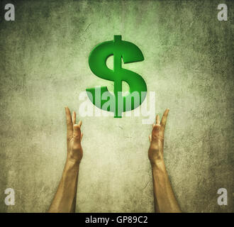 Closeup of two human hands holding a green dollar sign. Financial concept Stock Photo