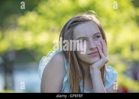 Portrait of happy Hispanic teen girl in park Stock Photo