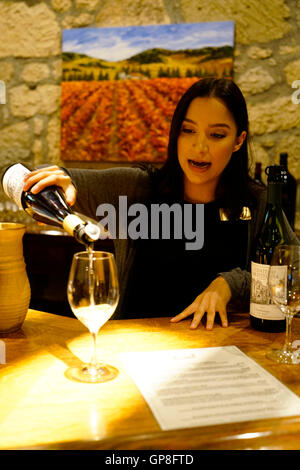 Hostess pouring white wine for visitors during a wine tasting session in Chateau Montelena winery,Calistoga,California,USA Stock Photo