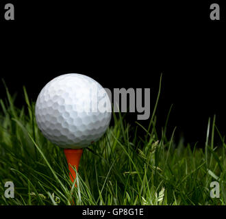 Golf Ball in long grass on a tee Stock Photo