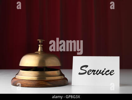 Copper bell in Hotel with a service sign Stock Photo