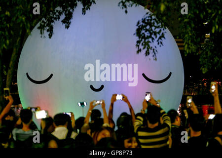 Seoul, South Korea. 3rd Sep, 2016. People take a picture of public art 'super moon' in Seokchon lake near Lotte World Tower. Public art project 'super moon' is made by public art group 'friends with you'. It will be shown through October 3th. Credit:  Min Won-Ki/ZUMA Wire/Alamy Live News Stock Photo