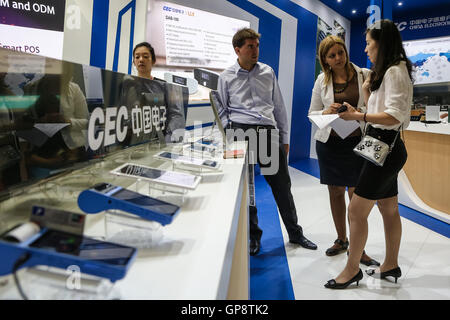 Berlin, Germany. 2nd Sep, 2016. Attendees talk at China Electronics Corporation (CEC) stand during the 2016 IFA consumer electronics fair in Berlin, Germany, on Sept. 2, 2016. Over 700 Chinese companies have taken part in IFA 2016 with their latest product highlights and services. © Zhang Fan/Xinhua/Alamy Live News Stock Photo