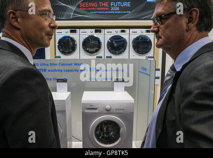 Berlin, Germany. 2nd Sep, 2016. Attendees speak in front of Midea's washing machines at Midea's stand during the 2016 IFA consumer electronics fair in Berlin, Germany, on Sept. 2, 2016. Over 700 Chinese companies have taken part in IFA 2016 with their latest product highlights and services. © Zhang Fan/Xinhua/Alamy Live News Stock Photo