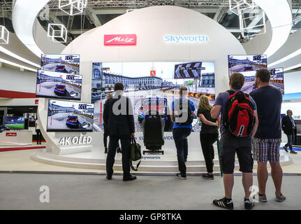 Berlin, Germany. 2nd Sep, 2016. Visitors view HD TVs at Skyworth's stand during the 2016 IFA consumer electronics fair in Berlin, Germany, on Sept. 2, 2016. Over 700 Chinese companies have taken part in IFA 2016 with their latest product highlights and services. © Zhang Fan/Xinhua/Alamy Live News Stock Photo
