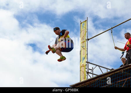 Person jumping off of a 5m high platform and in to an airbag as part of the Adrenaline rush race (for Macmillan), Bristol, 2016. Stock Photo