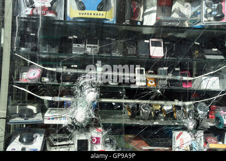 smashed window glass mobile phone shop Stock Photo