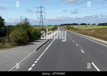 power lines crossing over trunk road england,united kingdom Stock Photo