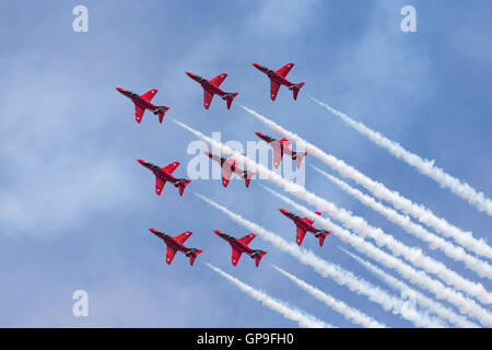 Royal Air Force (RAF) Red Arrows aerobatic display team flying British Aerospace Hawk jet trainer aircraft. Stock Photo