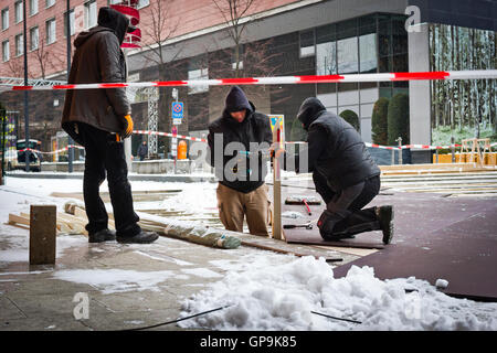 Men prepare the entrance to the Berlinale outside the Potsdamer Platz Theatre in Berlin, Germany. Stock Photo