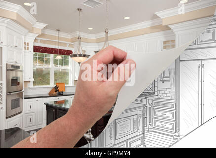 Male Hand Turning Page of Custom Kitchen Photograph to Drawing Underneath. Stock Photo