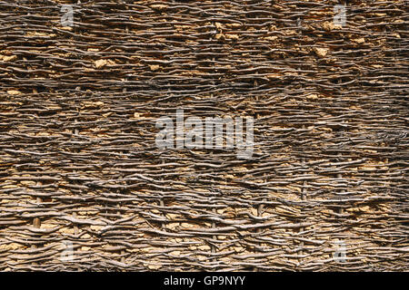 Wattled barn near the background wall and clay Stock Photo