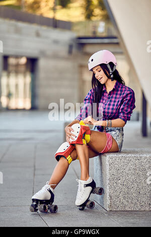 Active lifestyle girl is going to ride on roller skates. Stock Photo