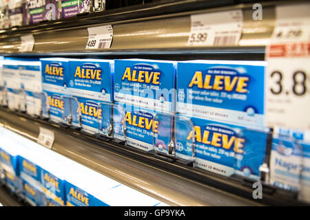Over the counter pain reliever Aleve on a shelf at a pharmacy Stock Photo