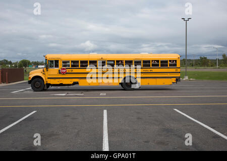 Students gesture as they wait in a parked school bus in a parking lot in Brainerd, Minnesota, USA Stock Photo