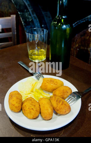 Croquettes serving with glass of cider. Spain. Stock Photo