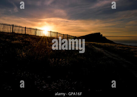 A spectacular sunset breaks over Porth Island in Newquay, Cornwall. Stock Photo