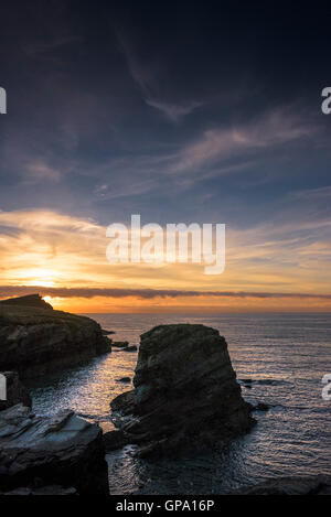 A spectacular sunset over Porth Island and Dollar Rock in Newquay, Cornwall. Stock Photo