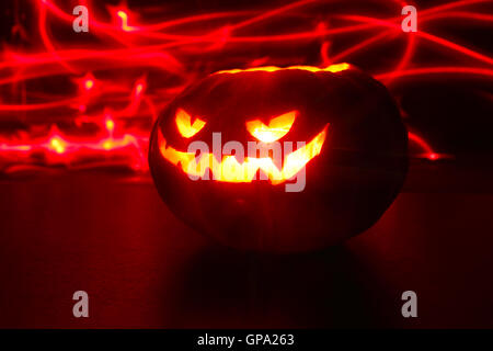 Illuminated cute halloween pumpkin isolated on black background Stock Photo