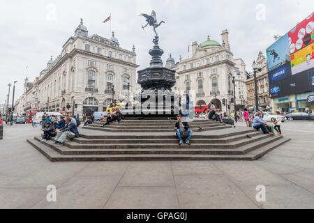 People enjoying a day out in London around Piccadilly Circus England Stock Photo