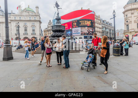 People enjoying a day out in London around Piccadilly Circus England Stock Photo