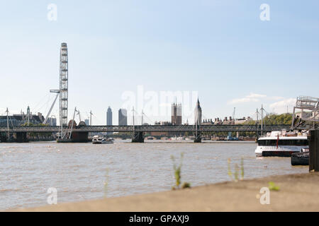 London, UK - 30 August 2016: View of London Eye and Hungerford Bridge from Embankment London over river Thames. Stock Photo