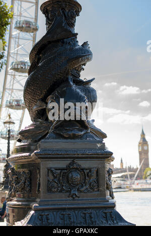 London, UK - 30 August 2016: Sturgeon Lamppost with London Eye and Big Ben in the background Stock Photo