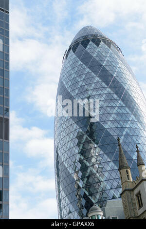 London, England - 31 August 2016: Urban landscape with the exterior of 30 St Mary Axe known as the Gherkin in the City of London Stock Photo