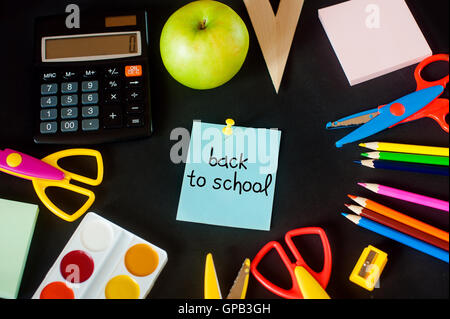 lot of school supplies, and in the center  the composition  note with the words - back to Stock Photo