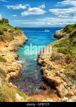 Tiny beach in rocky lagoon on Mediterranean Sea, Cala Manacor, Porto Cristo, Mallorca island, Spain Stock Photo