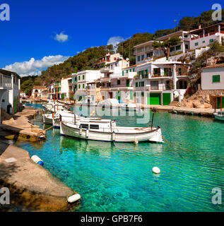 White villas and boats on green water in picturesque fishermen village Cala Figuera, Mediterranean Sea, Mallorca, Spain Stock Photo