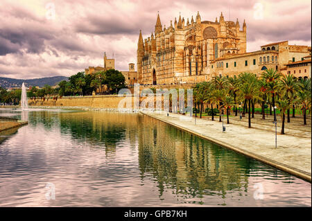 La Seu, the cathedral of Palma de Mallorca, reflecting in the water on sunset, Spain Stock Photo