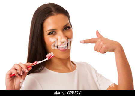 Woman cleaning teeth with toothbrush for perfect hygiene and healthy teeth. Stock Photo