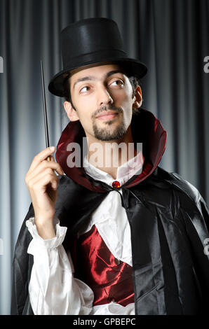 Magician doing tricks on white Stock Photo