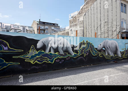 polar bear mural on protective hoardings surround a building site in downtown reykjavik Iceland Stock Photo