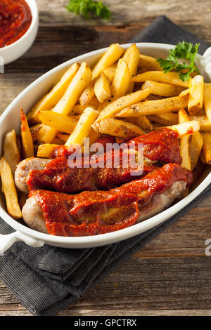 Homemade Currywurst and French Fries in a Bowl Stock Photo