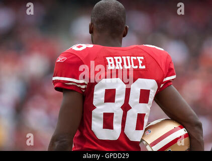 San Francisco 49ers Isaac Bruce (88) joins teammates at the center of the  field as an honorary captain for a coin toss before a game against the St.  Louis Rams at the