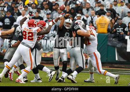 November 7, 2010; Oakland, CA, USA;  Kansas City Chiefs linebacker Derrick Johnson (56) deflects a pass from Oakland Raiders quarterback Jason Campbell (8) during the first quarter at Oakland-Alameda County Coliseum. Stock Photo