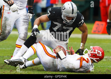 November 7, 2010; Oakland, CA, USA;  Oakland Raiders defensive end Matt Shaughnessy (77) tackles Kansas City Chiefs quarterback Matt Cassel (7) after a run during the first quarter at Oakland-Alameda County Coliseum. Stock Photo