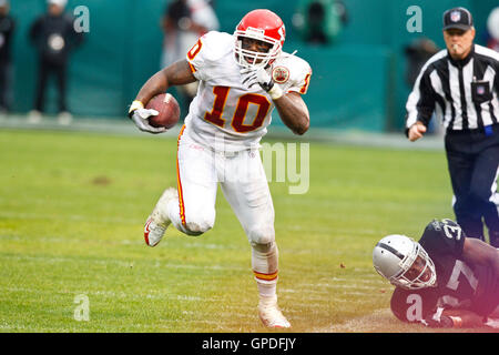 November 7, 2010; Oakland, CA, USA;  Kansas City Chiefs wide receiver Terrance Copper (10) breaks a tackle from Oakland Raiders cornerback Chris Johnson (37) during the second quarter at Oakland-Alameda County Coliseum. Stock Photo