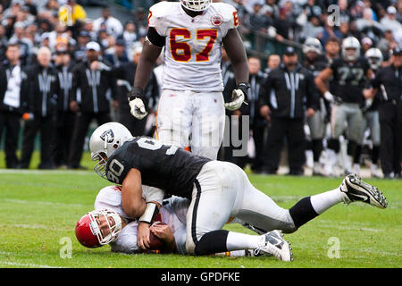 November 7, 2010; Oakland, CA, USA;  Kansas City Chiefs quarterback Matt Cassel (7) is tackled by Oakland Raiders defensive tackle Desmond Bryant (90) during the third quarter at Oakland-Alameda County Coliseum. Oakland defeated Kansas City 23-20 in overt Stock Photo