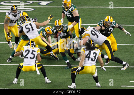 Feb 6, 2011; Arlington, TX, USA; Green Bay Packers running back James Starks (44) rushes between Pittsburgh Steelers defensive end Brett Keisel (99) and safety Troy Polamalu (43) and safety Ryan Clark (25) during the first half of Super Bowl XLV at Cowboy Stock Photo