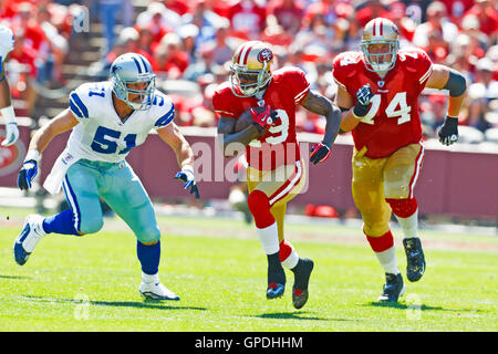 September 18, 2011; San Francisco, CA, USA;  San Francisco 49ers wide receiver Ted Ginn (19) rushes past Dallas Cowboys linebacker Keith Brooking (51) during the first quarter at Candlestick Park.  Dallas defeated San Francisco 27-24 in overtime. Stock Photo