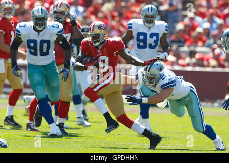 September 18, 2011; San Francisco, CA, USA; San Francisco 49ers wide receiver Ted Ginn (19) rushes past Dallas Cowboys linebacker Keith Brooking (51) during the second quarter at Candlestick Park. Stock Photo
